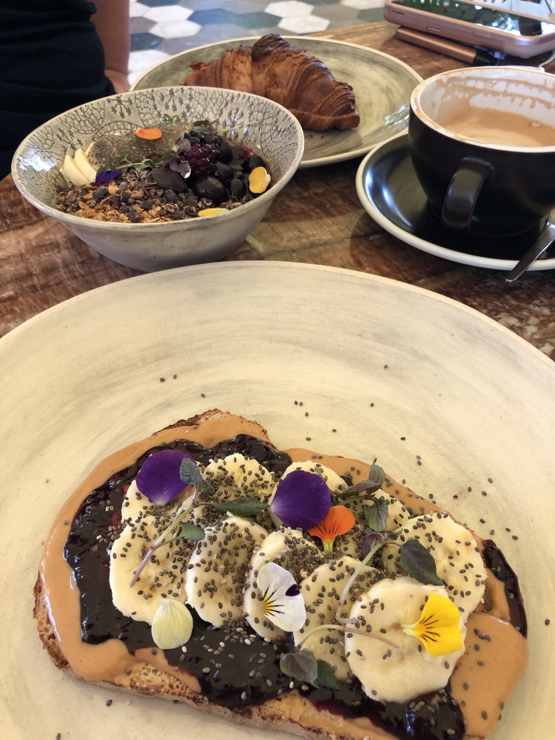 P&J toast with edible flowers and granola bowl at Brew Coffee Company