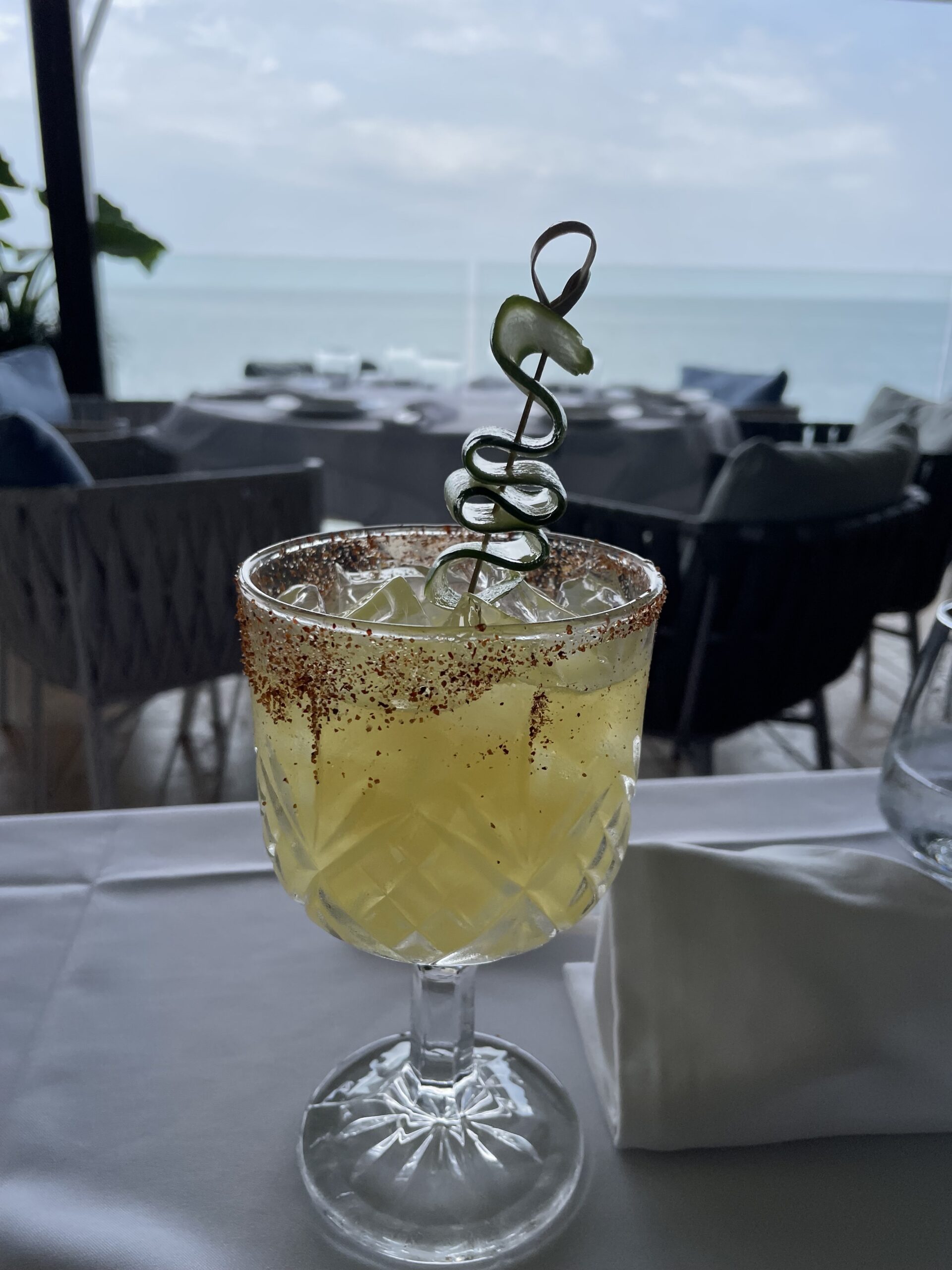 Golden craft cocktail with chili rim at La Vespa Vista Mare